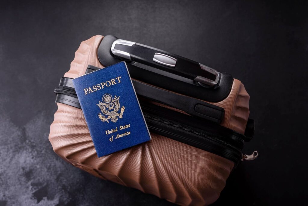 a U.S. Passport sitting atop luggage for a cruise.